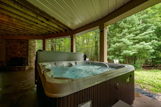 Hot tub on the patio at Woodland Chalet, controllable from the guest app